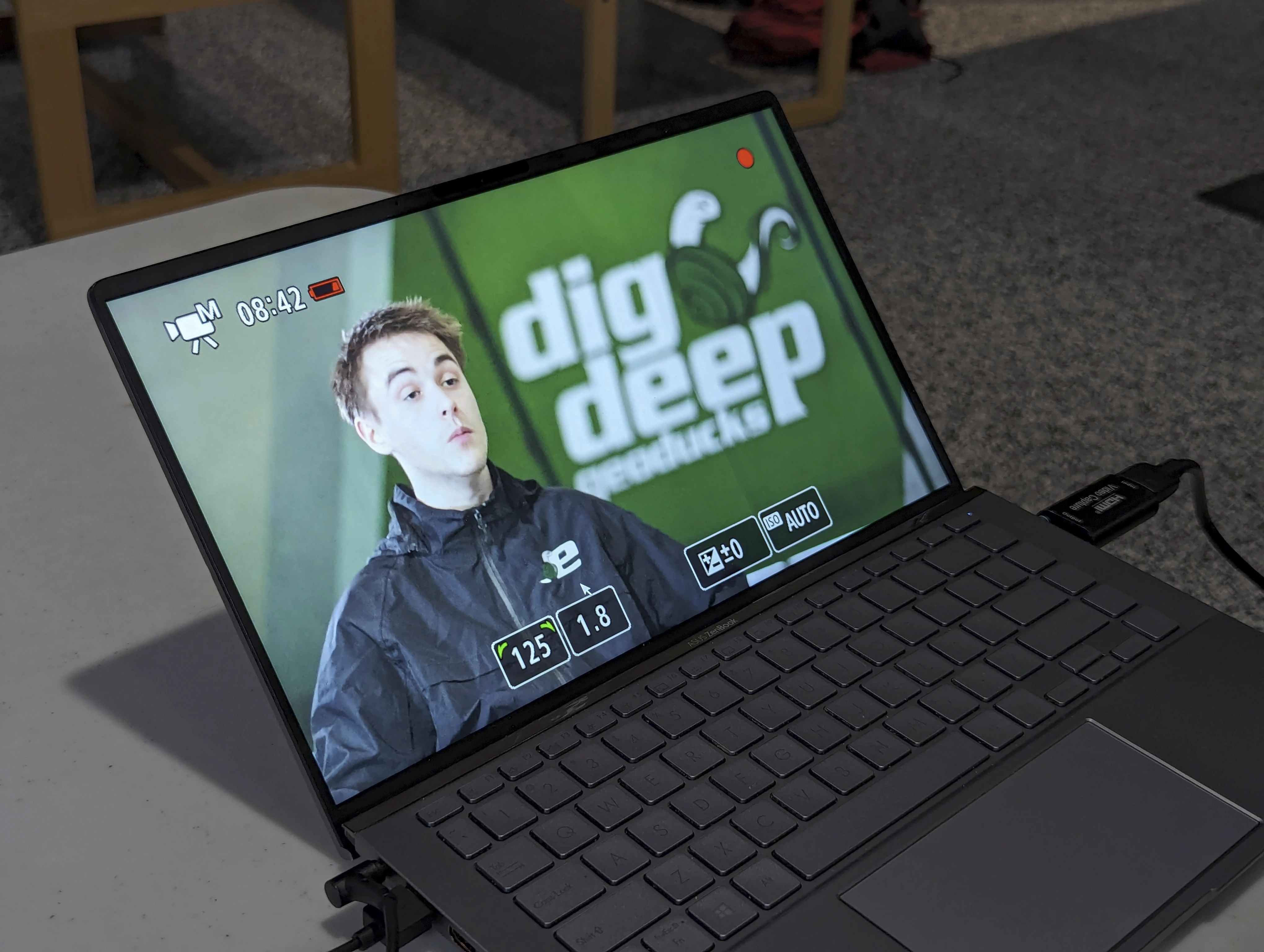 A photohraph of a laptop showcasing behind the scenes footage of an interview.